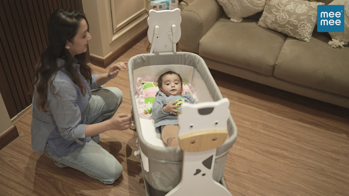 Demonstration of Mee Mee Manual Swing Cradle for newborn baby with mosquito net and mattress pad.